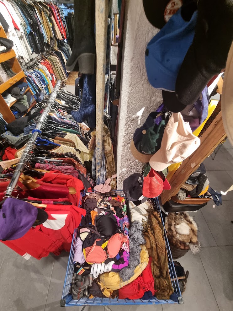 Intérieur de boutique rempli de vêtements, accessoires et portants